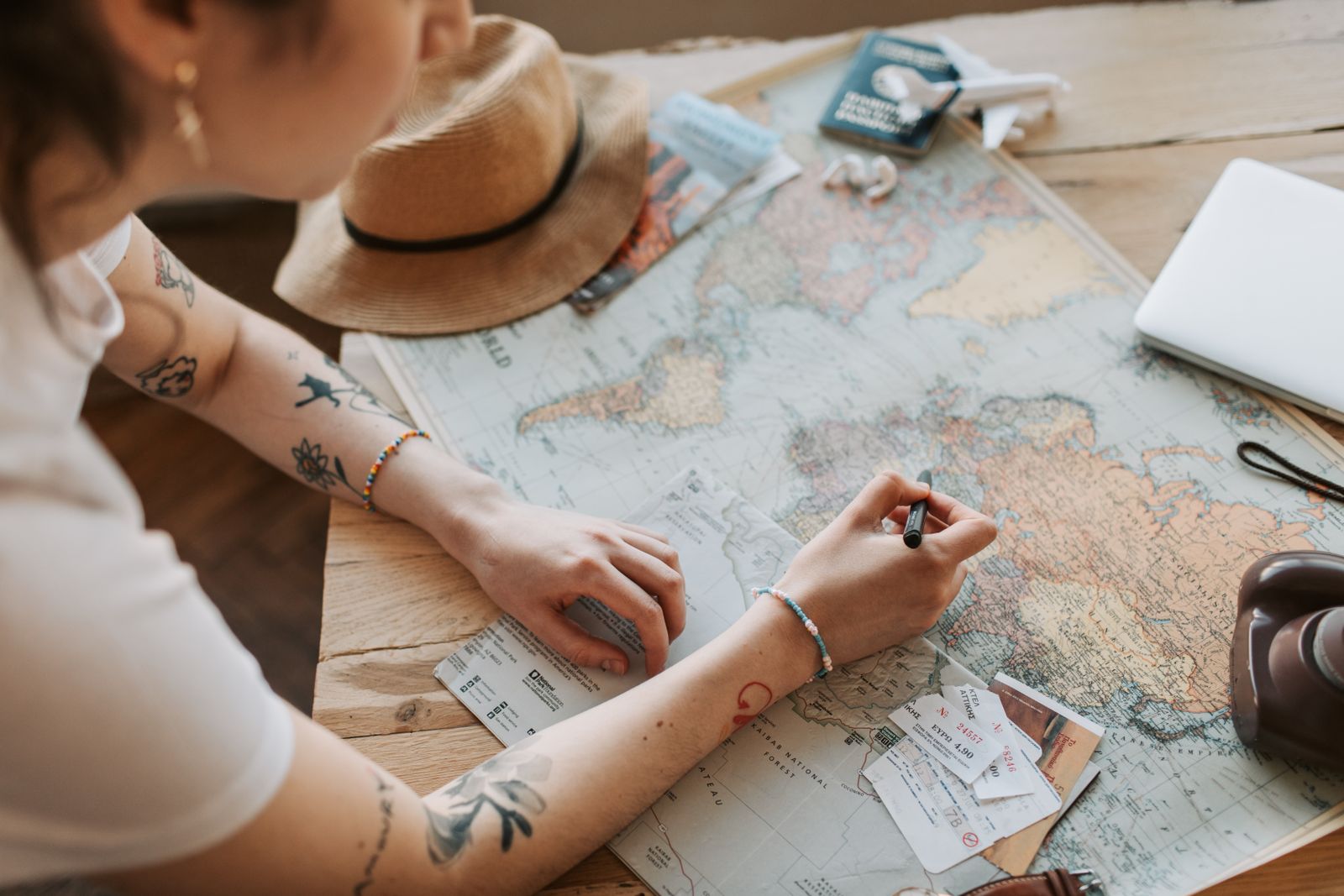 Hands planning a trip over a map