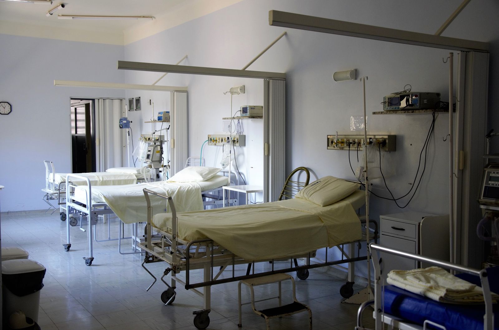 Hospital ward with neatly made medical beds
