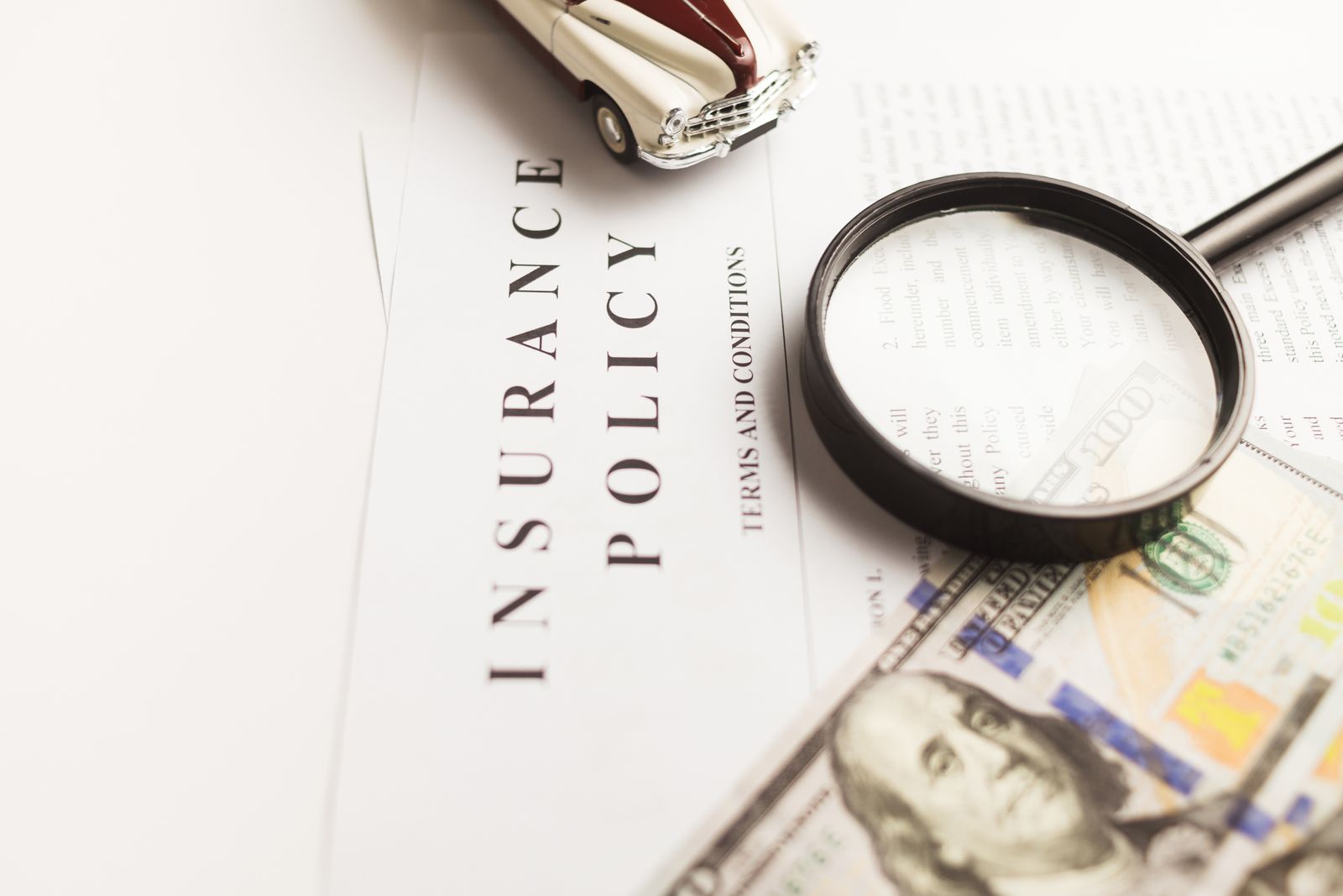 Insurance policy document under a magnifying glass