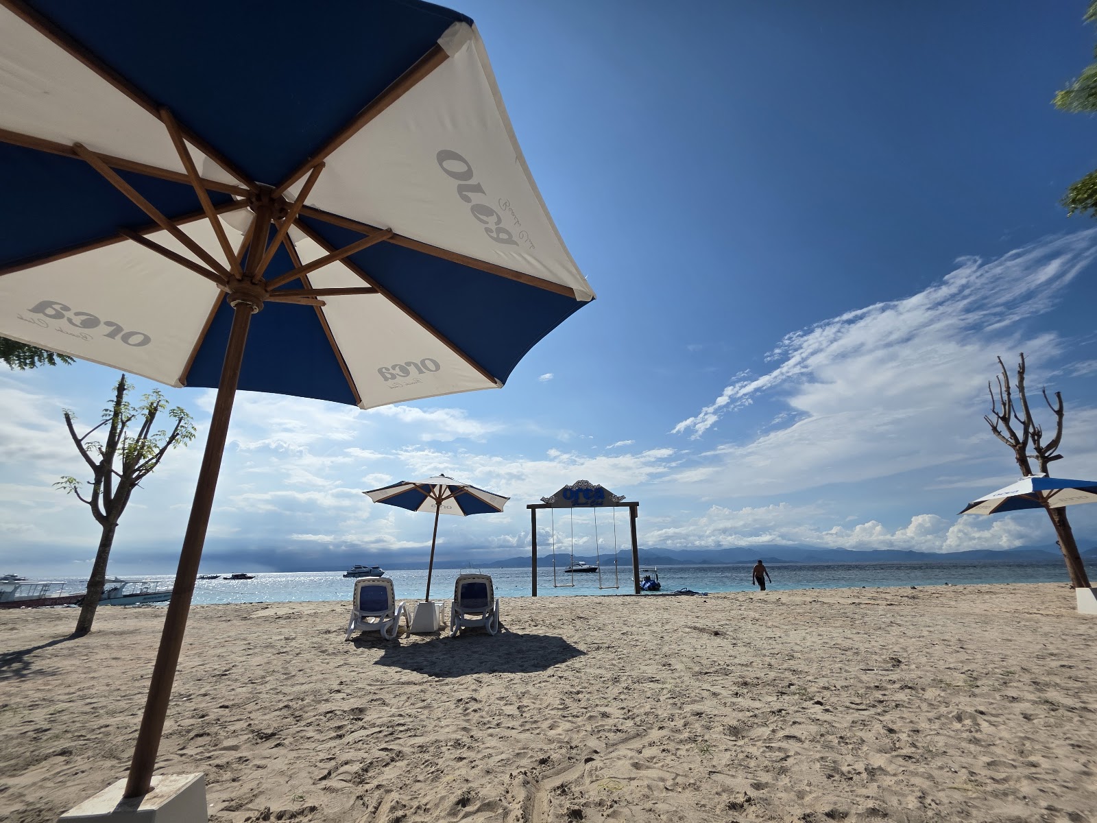 Umbrellas and daybeds facing the sea