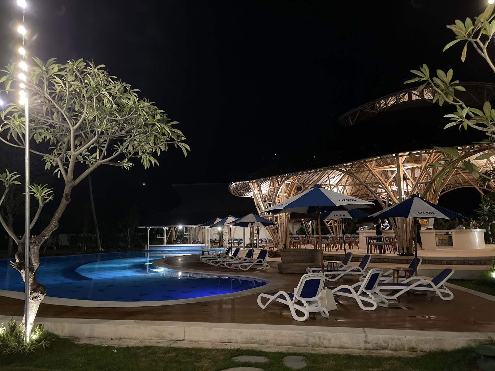 Orca Beach Club pool area in the evening