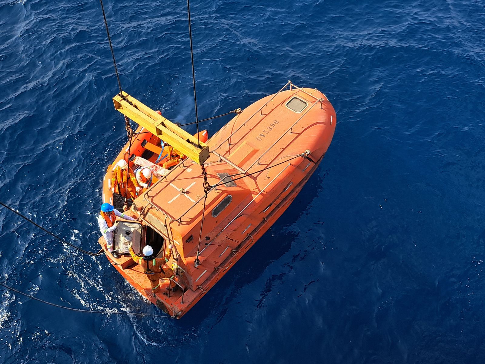 Orange rescue lifeboat on the open ocean
