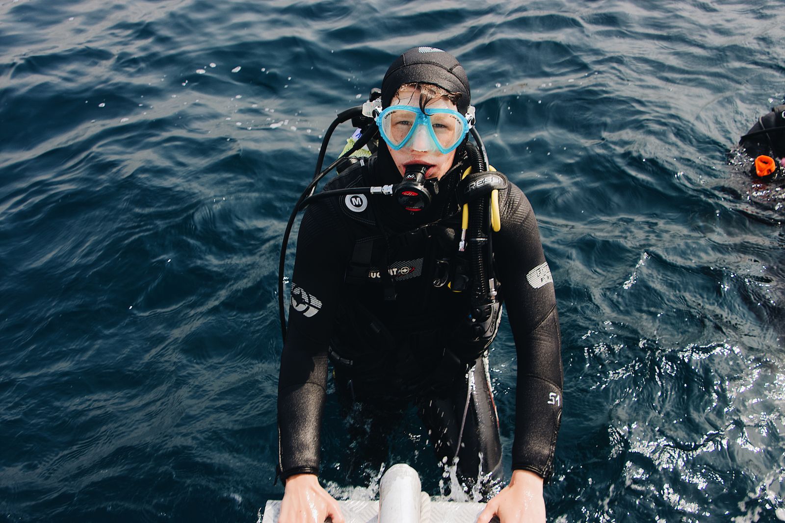 Scuba diver preparing to dive in the ocean
