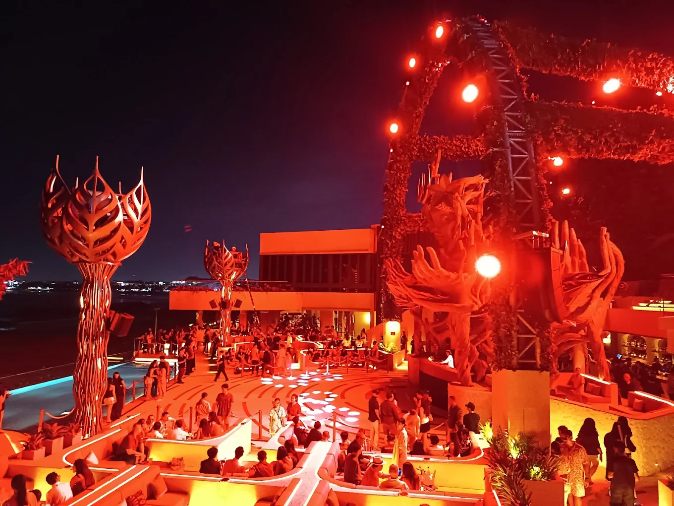 Crowd enjoying a night party under red lights