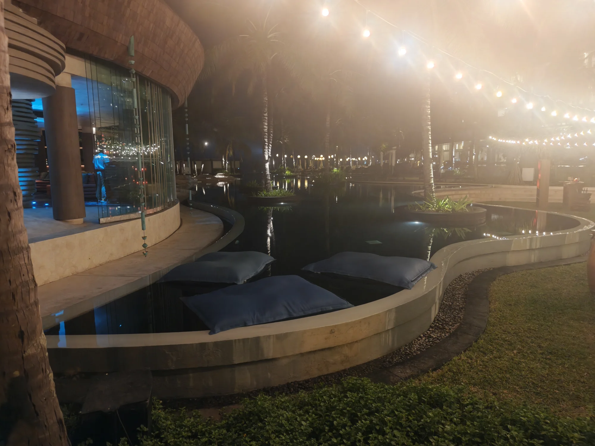 Pool edge with daybeds under string lights