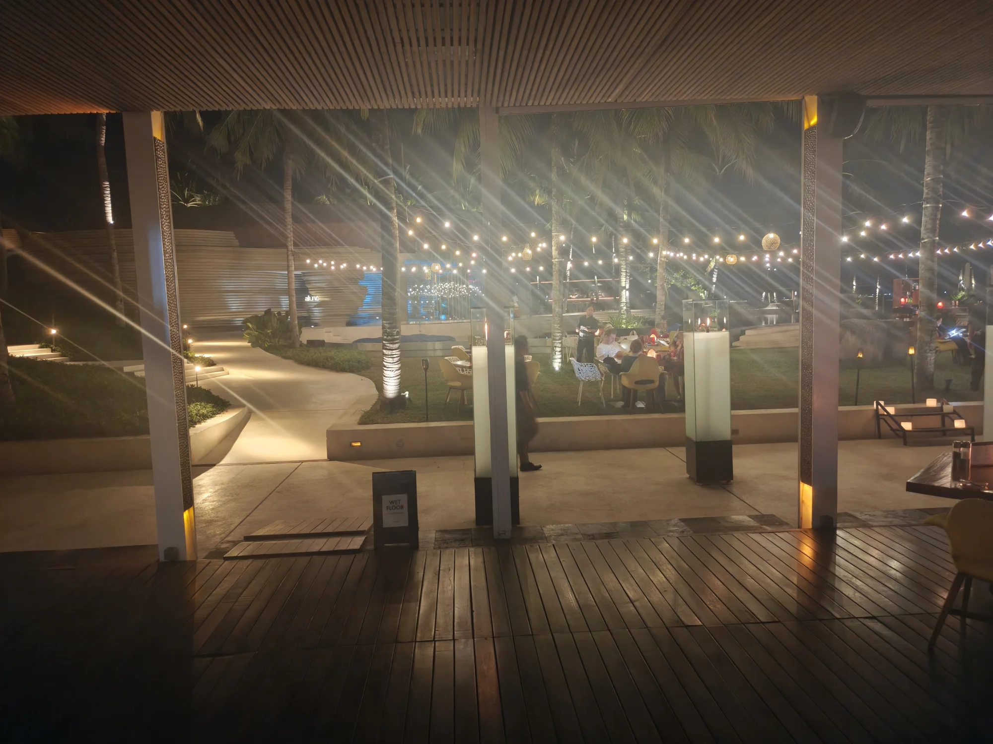 Wooden walkway with string lights leading out of the venue