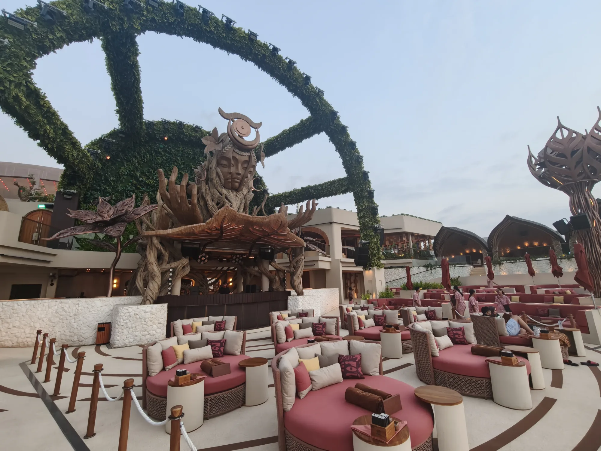 Sunken lounge seating area with red cushions at Zumana Beach Club